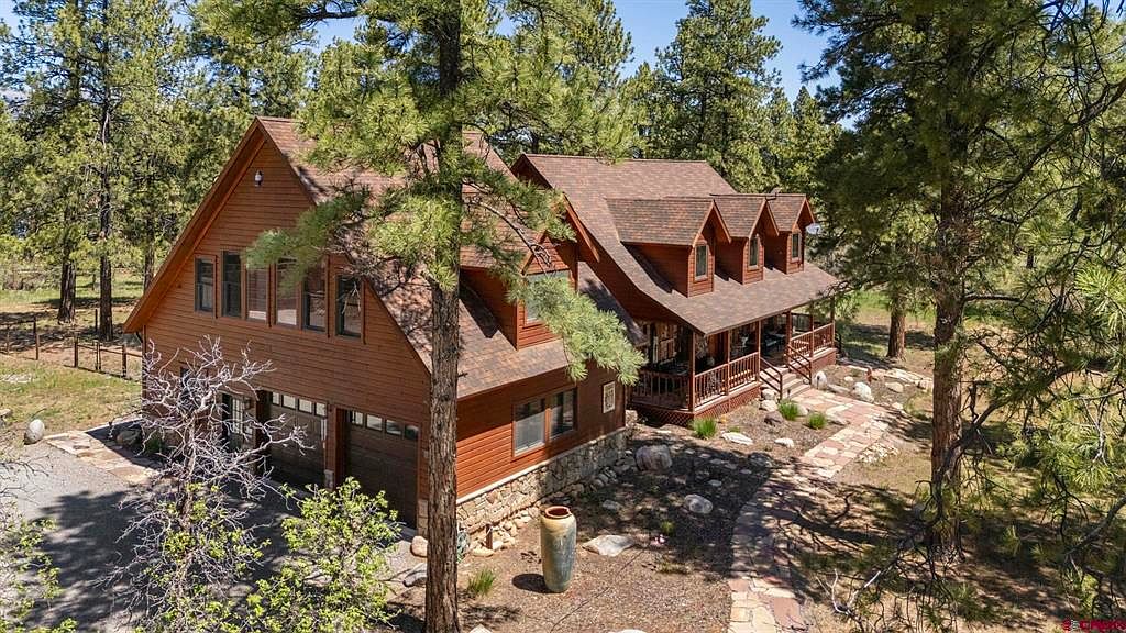 185 Shenandoah Terrace, a stone-and-cherry Colorado lodge tucked into a ponderosa pine forest in Durango